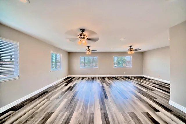 a view of an empty room and wooden floor