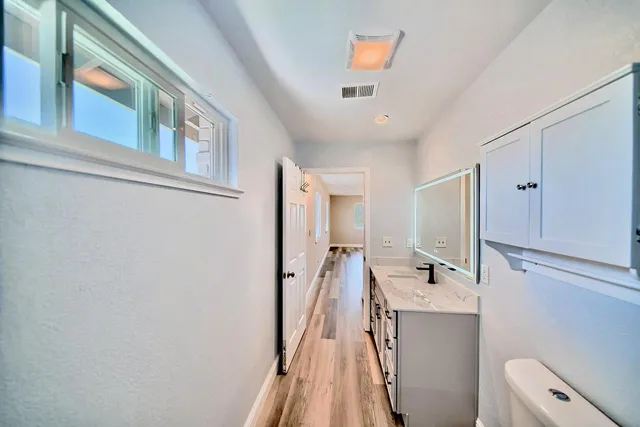 a bathroom with a sink a mirror and a toilet