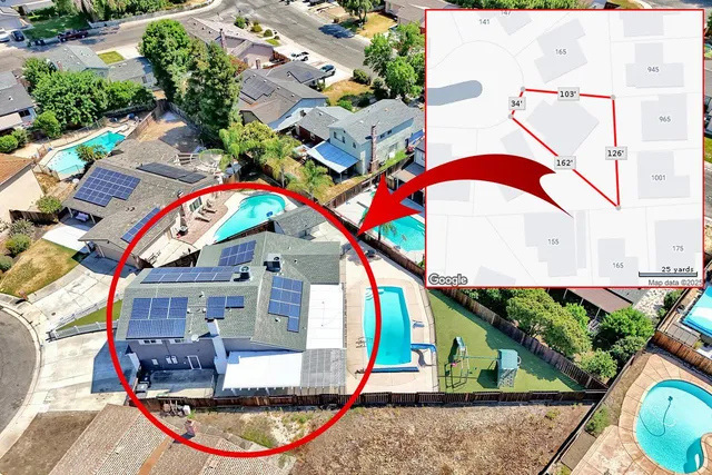 an aerial view of a house with swimming pool and outdoor space