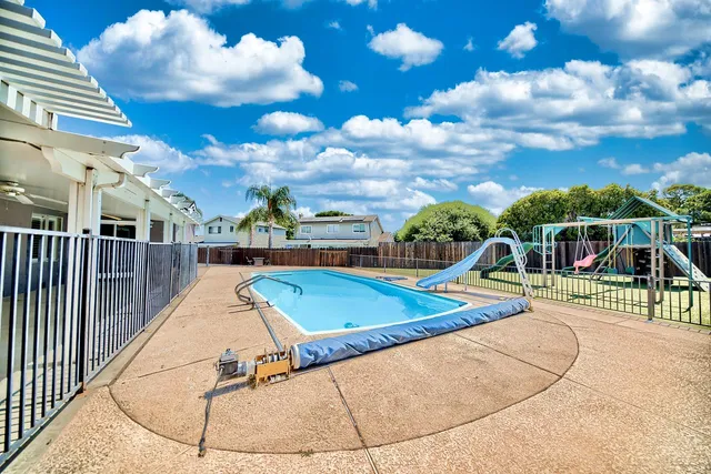 a view of a swimming pool with a lounge chairs