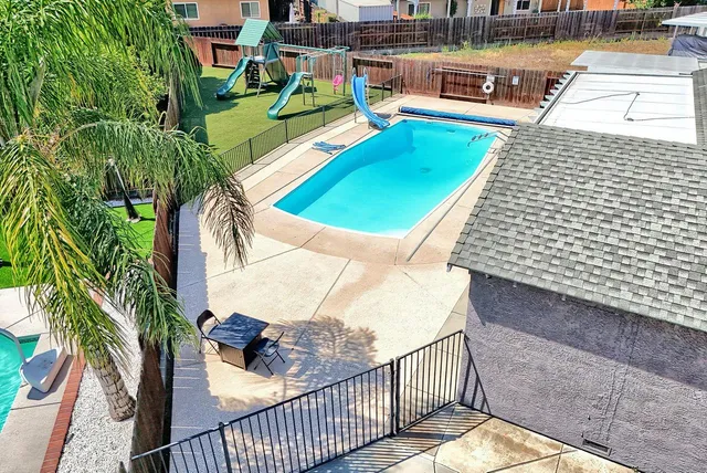 a view of a swimming pool with a patio