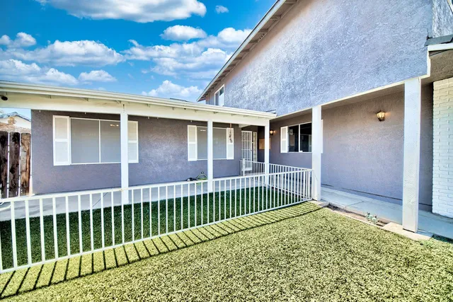 a view of a house with a wooden deck
