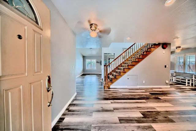 a view of entryway and hall with wooden floor