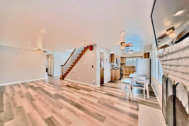 a view of a livingroom with furniture and staircase