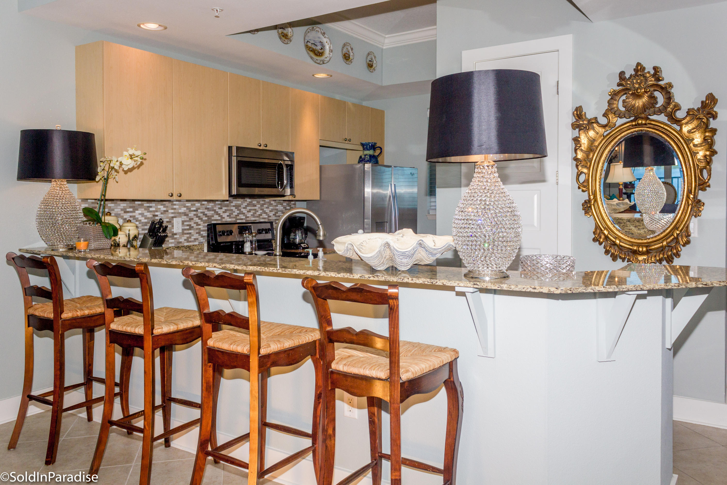 211 Durango Road, Unit 316 Destin, FL 32541 - Photo 13 of 48 a kitchen with a dining table and chairs