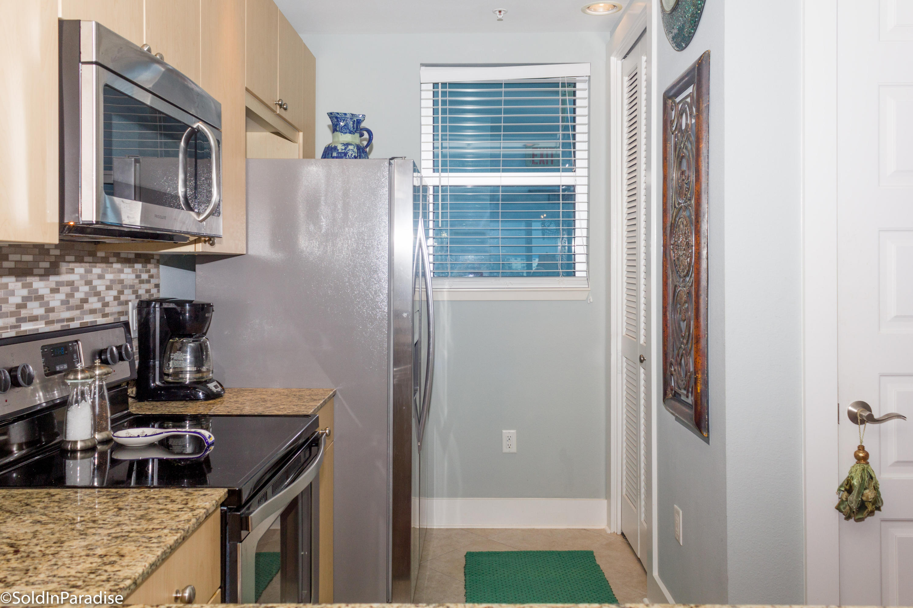 211 Durango Road, Unit 316 Destin, FL 32541 - Photo 16 of 48 a kitchen with a refrigerator and a stove top oven