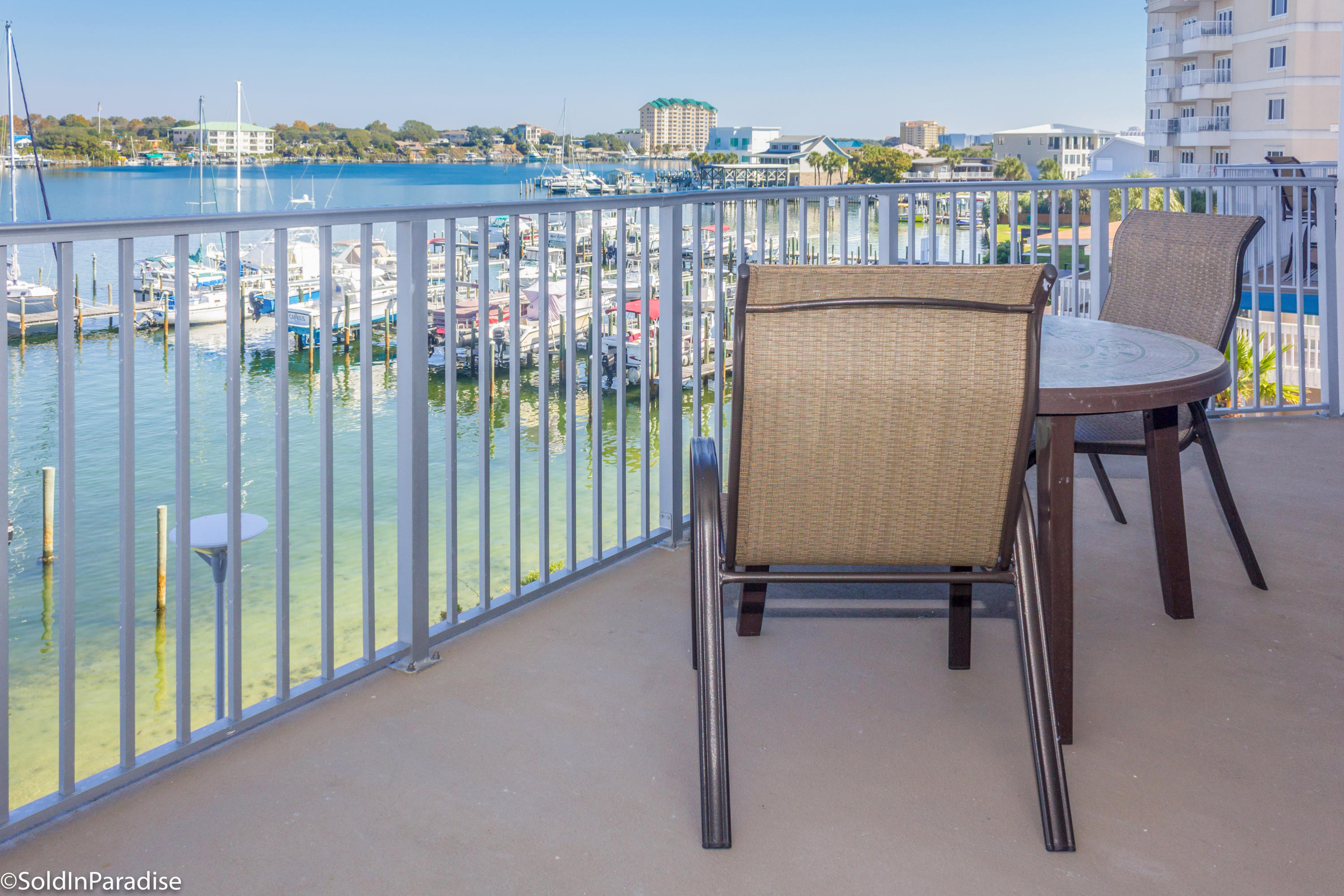 211 Durango Road, Unit 316 Destin, FL 32541 - Photo 8 of 48 a view of a chairs and table in the balcony