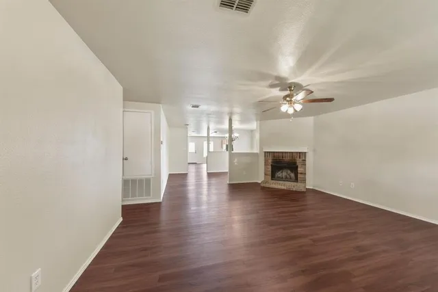 a view of a room with wooden floor and fireplace