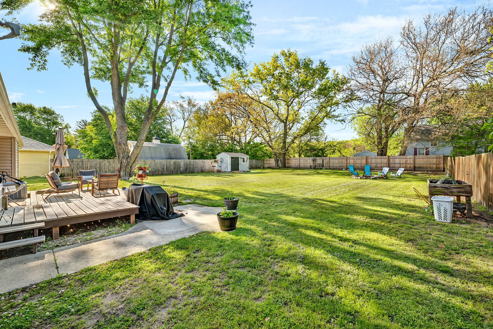 338 Orchard Lane Braidwood, IL 60408 - Photo 21 of 25 a view of a garden with lawn chairs and a fire pit