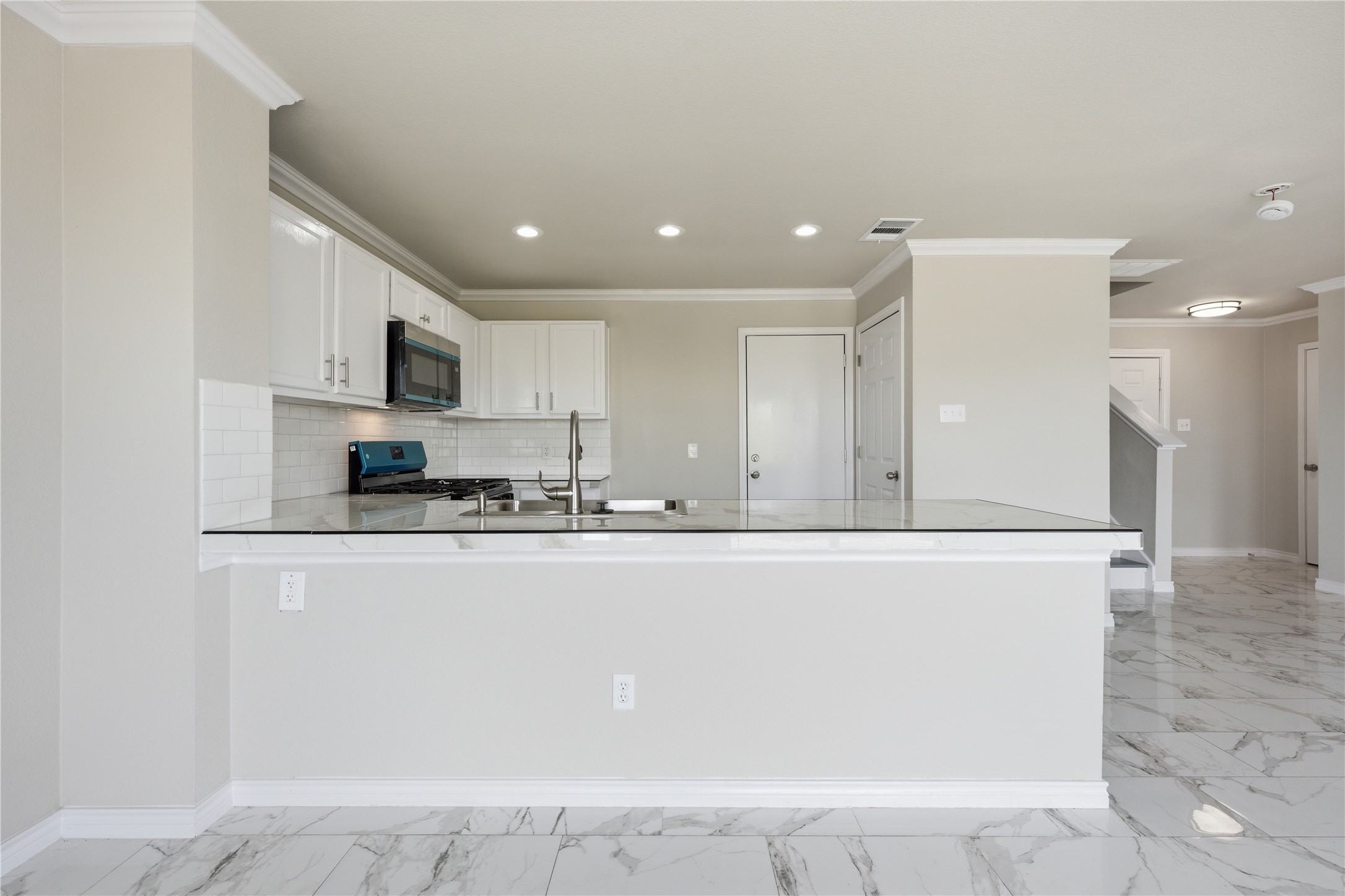 6917 Panda Royle Drive Del Valle, TX 78617 - Photo 8 of 23 A sleek kitchen features modern appliances and a clean design, perfect for entertaining.