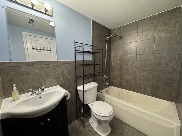a bathroom with a sink toilet and shower