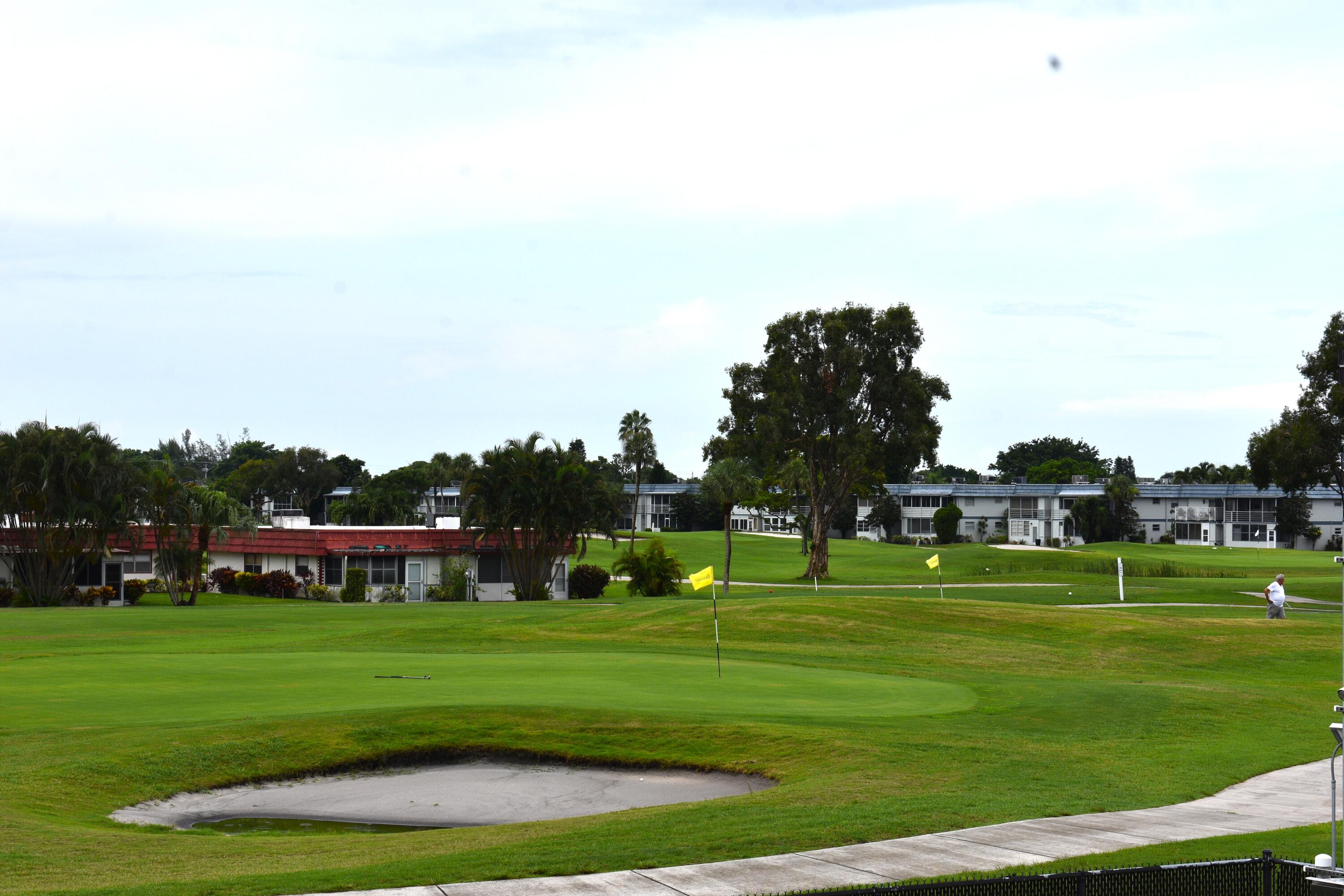 196 Tuscany C Delray Beach, FL 33446 - Photo 1 of 39 a view of grassy field with benches