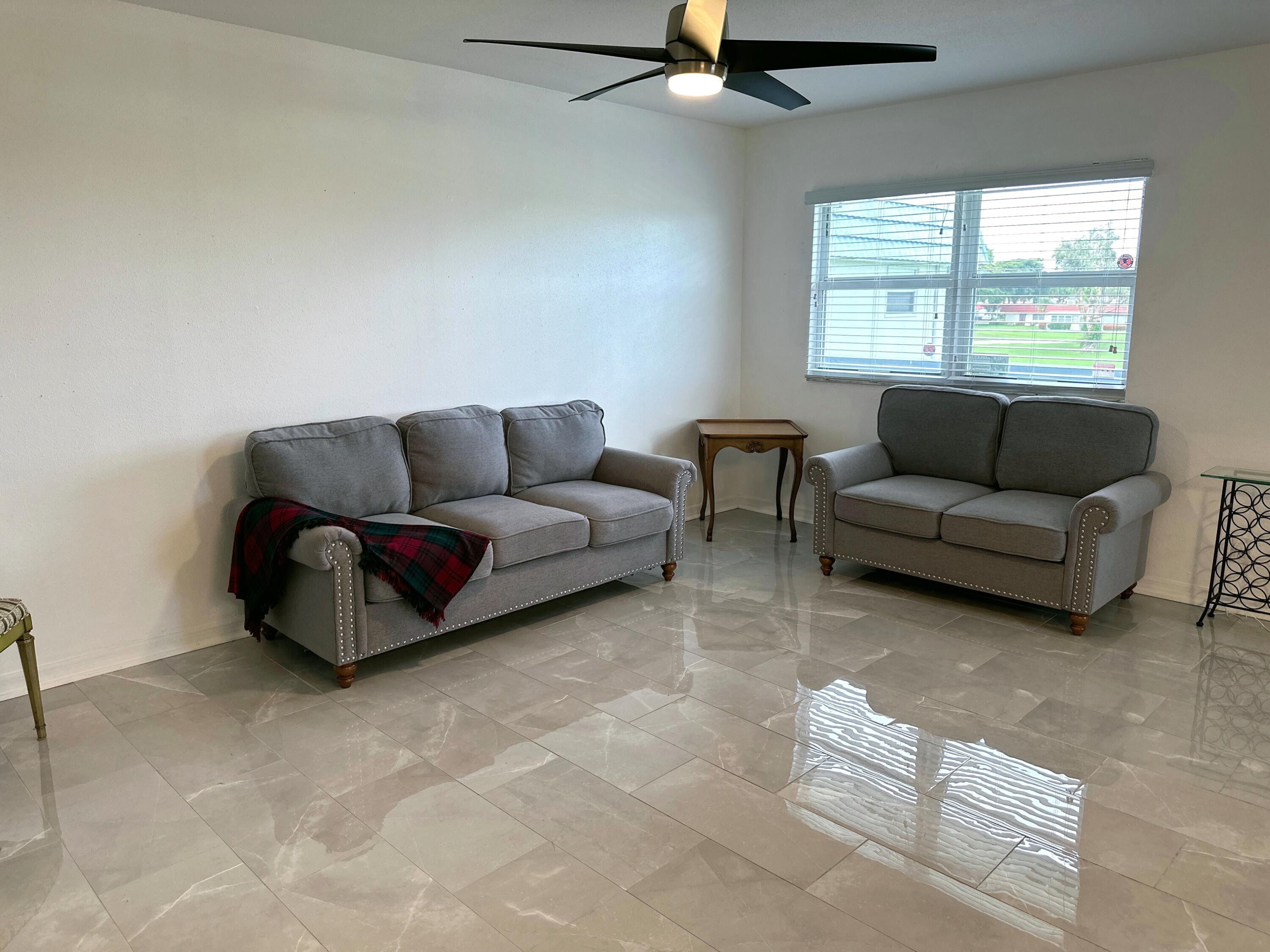 196 Tuscany C Delray Beach, FL 33446 - Photo 14 of 39 a living room with furniture and a window