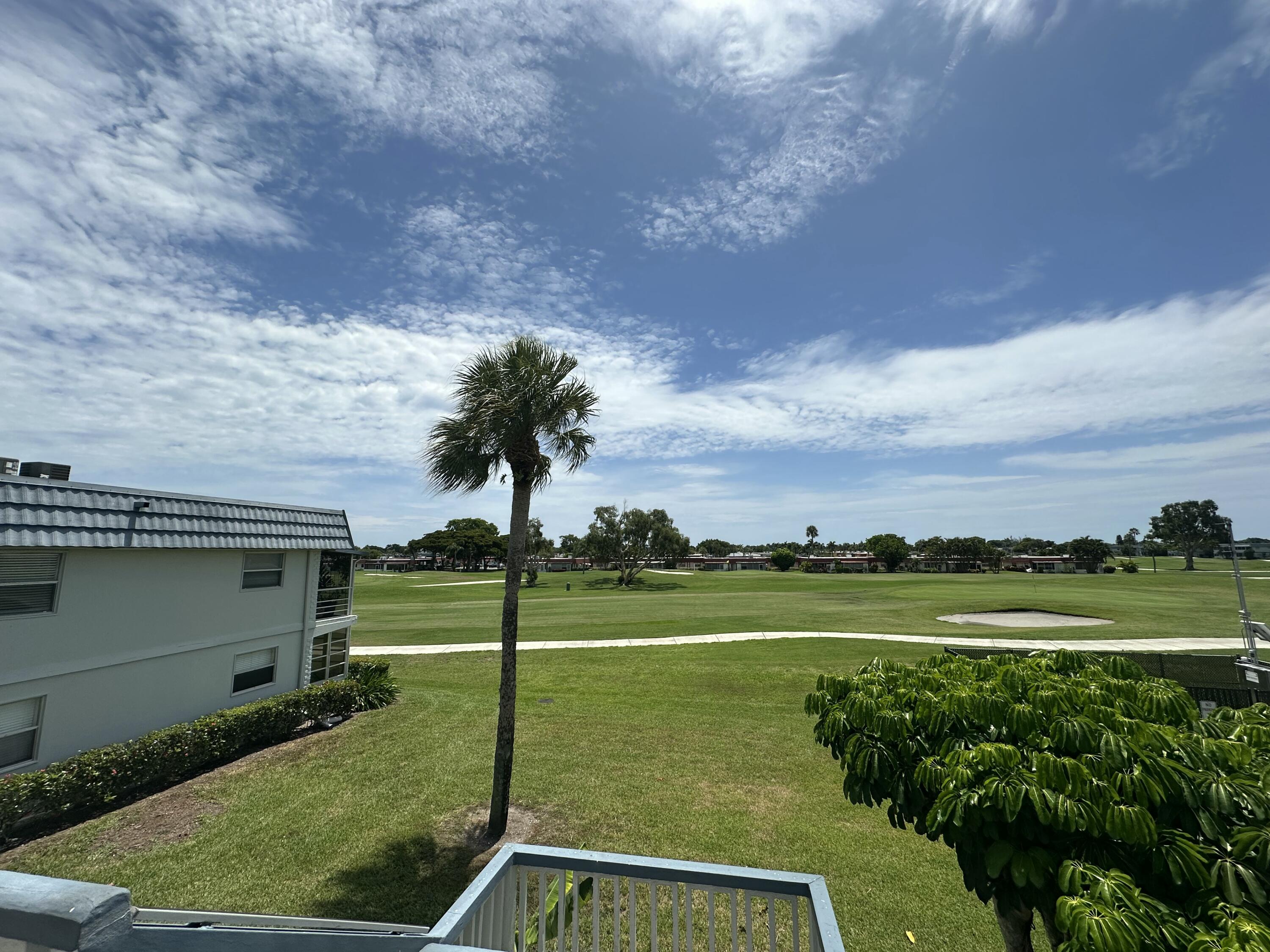 196 Tuscany C Delray Beach, FL 33446 - Photo 18 of 39 a view of a golf course with a lake view