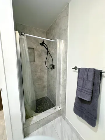 a bathroom with a shower and a sink
