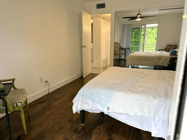 a bedroom with a bed window and a table