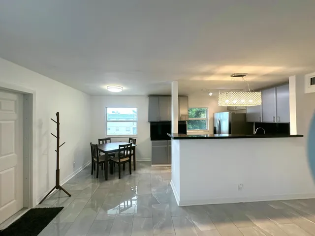 a view of a dining room with furniture and chandelier