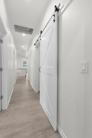 a view of storage and utility room with wooden floor