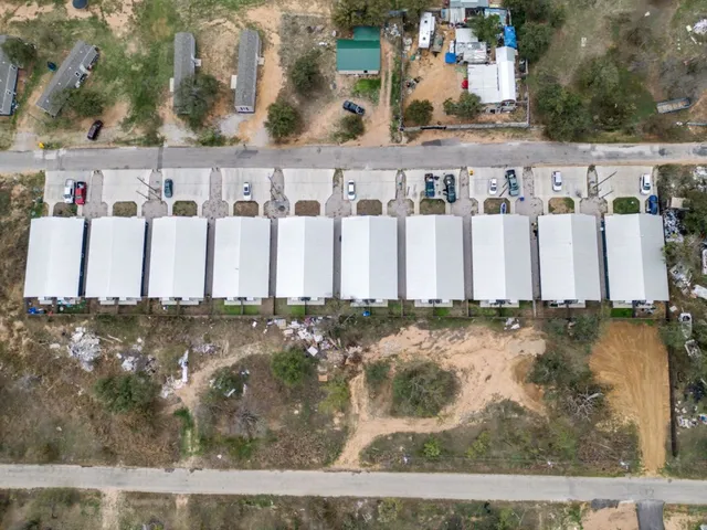 an aerial view of residential houses with outdoor space