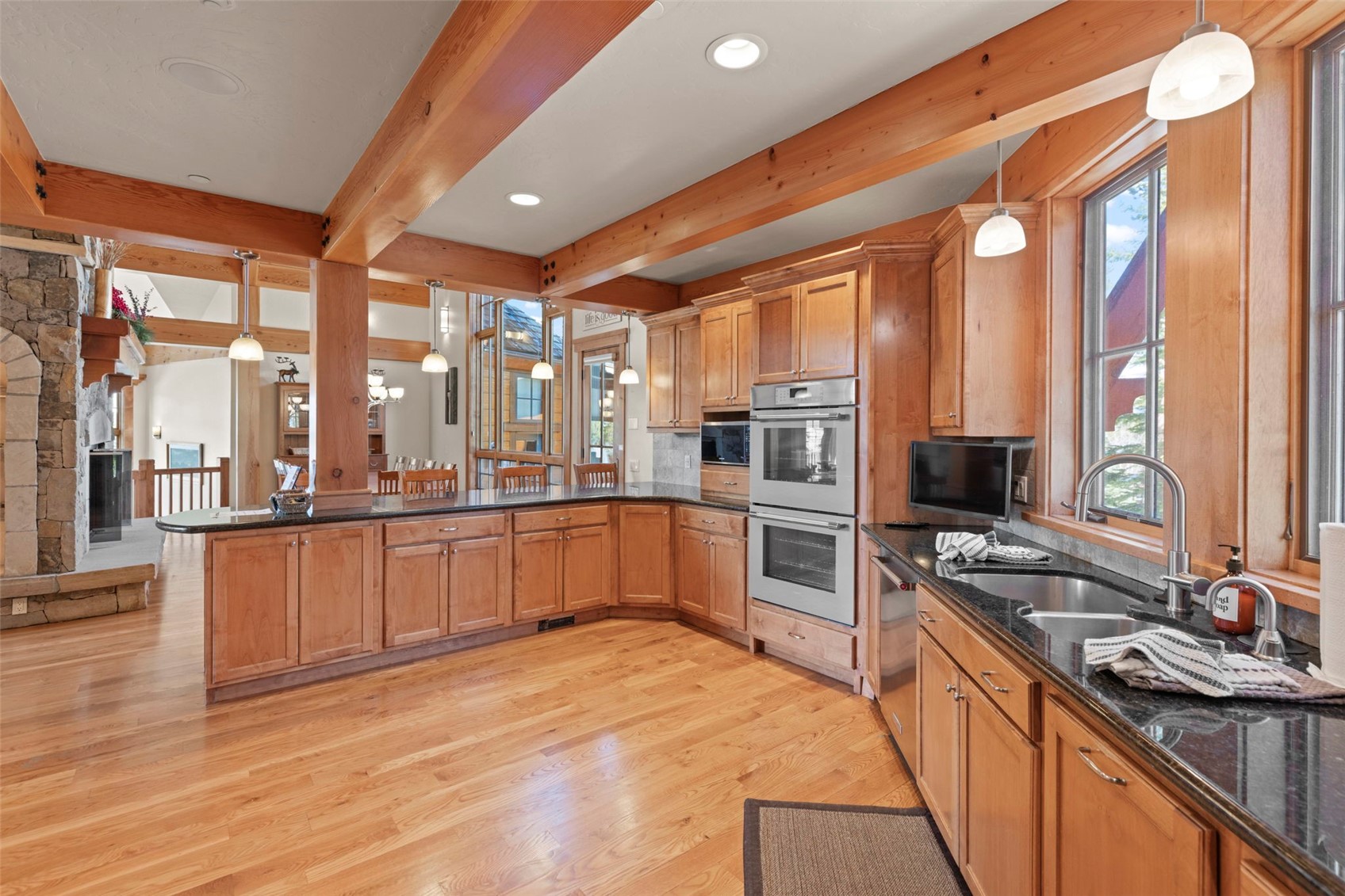 317 Timbertrail Road Breckenridge, CO 80424 - Photo 21 of 50 a large kitchen with a large counter top stainless steel appliances and a large window