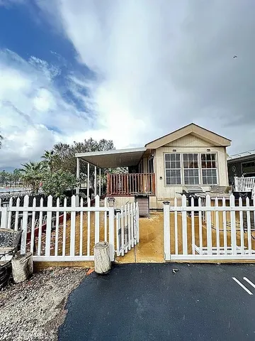 a view of a house with a wooden deck