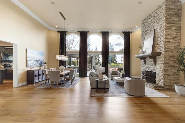 a living room with furniture a large window and a chandelier