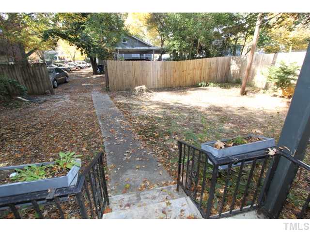 410 Chamberlain Street Raleigh, NC 27607 - Photo 13 of 14 a view of a backyard with wooden fence