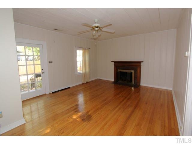 410 Chamberlain Street Raleigh, NC 27607 - Photo 2 of 14 a view of an empty room with a window and wooden floor