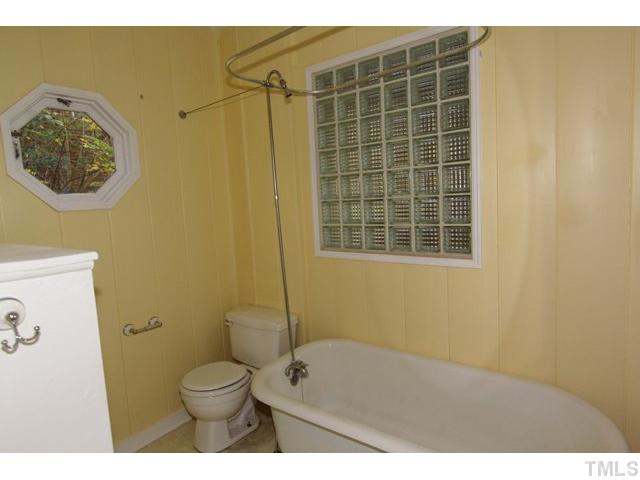 410 Chamberlain Street Raleigh, NC 27607 - Photo 10 of 14 a bathroom with a toilet and a shower