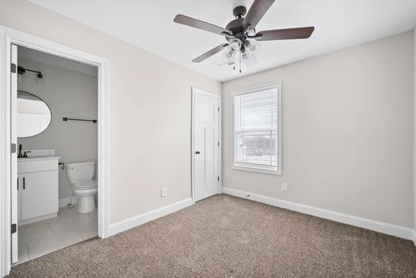 a bathroom with a toilet sink and a mirror