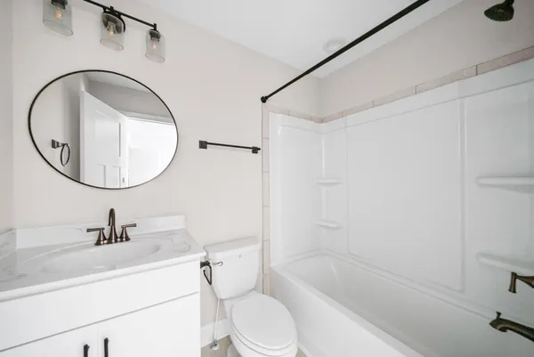 a bathroom with a sink a toilet and a mirror