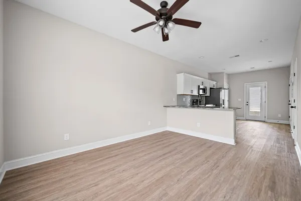 a view of a kitchen with a dishwasher and wooden floor