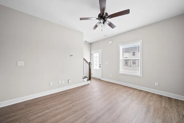 wooden floor in an empty room with a window