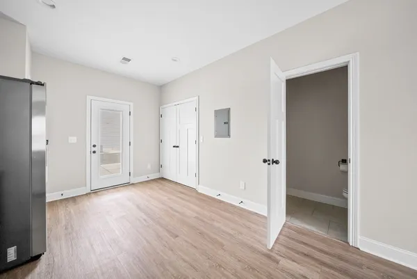 a view of an empty room with wooden floor