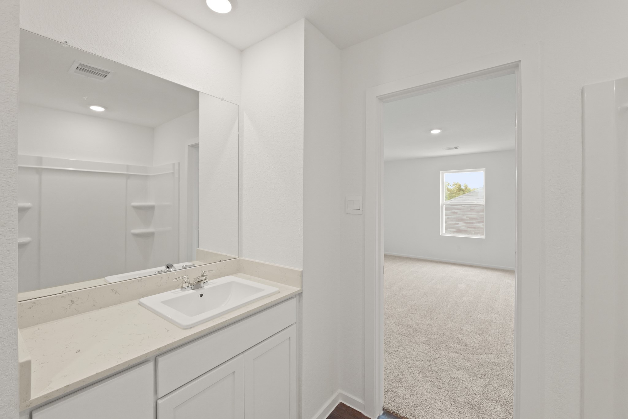 20026 Fibonacci Street New Caney, TX 77357 - Photo 12 of 22 a bathroom with a sink double vanity and a mirror