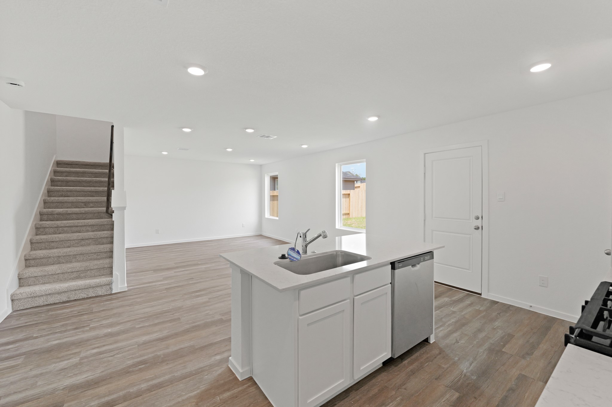 20026 Fibonacci Street New Caney, TX 77357 - Photo 2 of 22 a room with a sink wooden floor and white cabinet