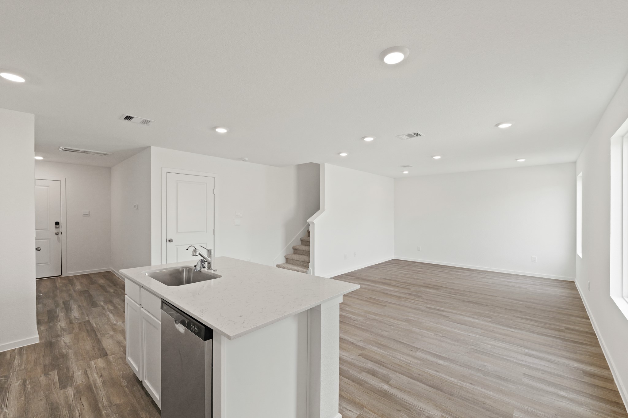 20026 Fibonacci Street New Caney, TX 77357 - Photo 3 of 22 a kitchen with a sink cabinets and wooden floor