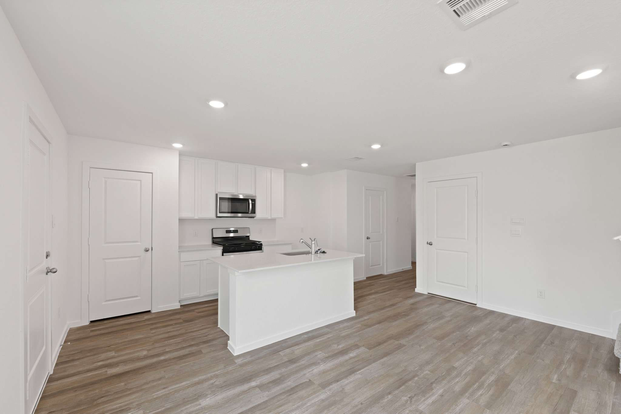 20026 Fibonacci Street New Caney, TX 77357 - Photo 4 of 22 a kitchen with a refrigerator and a stove top oven