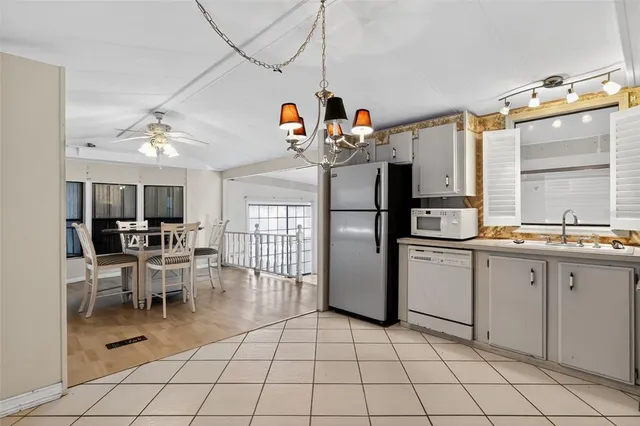 a kitchen with stainless steel appliances a refrigerator sink and cabinets