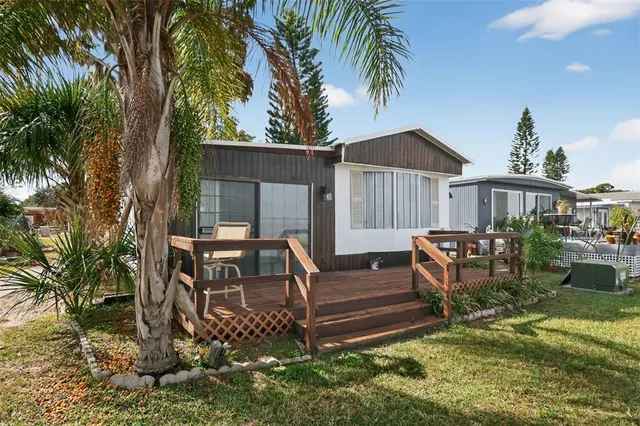 a swimming pool with outdoor seating and yard