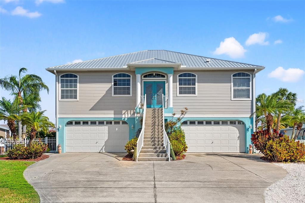 4207 Carlos Court Hernando Beach, FL 34607 - Photo 1 of 1 a front view of a house with a yard and garage