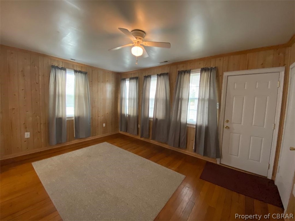 536 Buckley Hall Road Dutton, VA 23050 - Photo 5 of 11 an empty room with wooden floor and windows