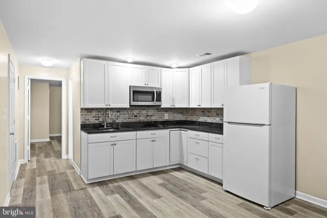 a view of a roof deck with chair and wooden fence