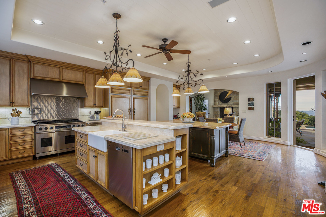 2838 East Valley Road Santa Barbara, CA 93108 - Photo 11 of 28 a kitchen with stove and wooden floor