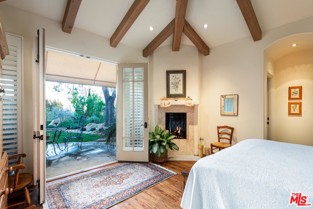 2838 East Valley Road Santa Barbara, CA 93108 - Photo 14 of 28 a bedroom with a bed and a fireplace