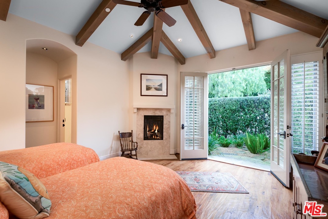 2838 East Valley Road Santa Barbara, CA 93108 - Photo 15 of 28 a bedroom with a bed and a fireplace