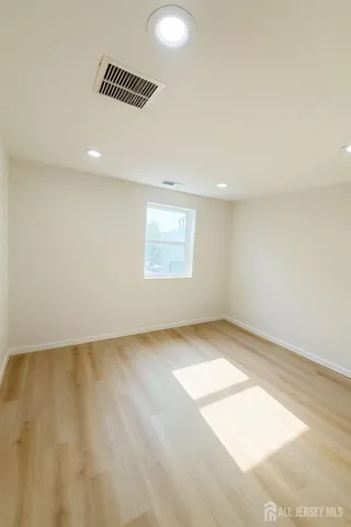 an empty room with a empty space and windows