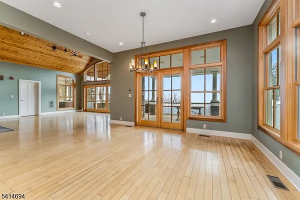 a large kitchen with stainless steel appliances granite countertop a stove and a wooden floors