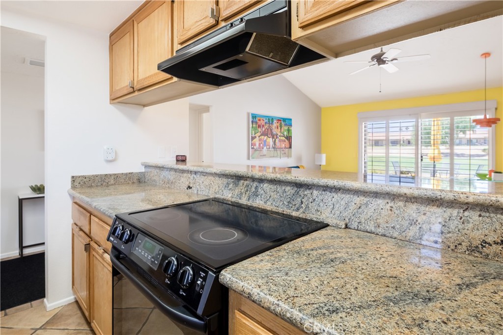 40657 Preston Trail Palm Desert, CA 92211 - Photo 16 of 46 a kitchen with a stove and a sink