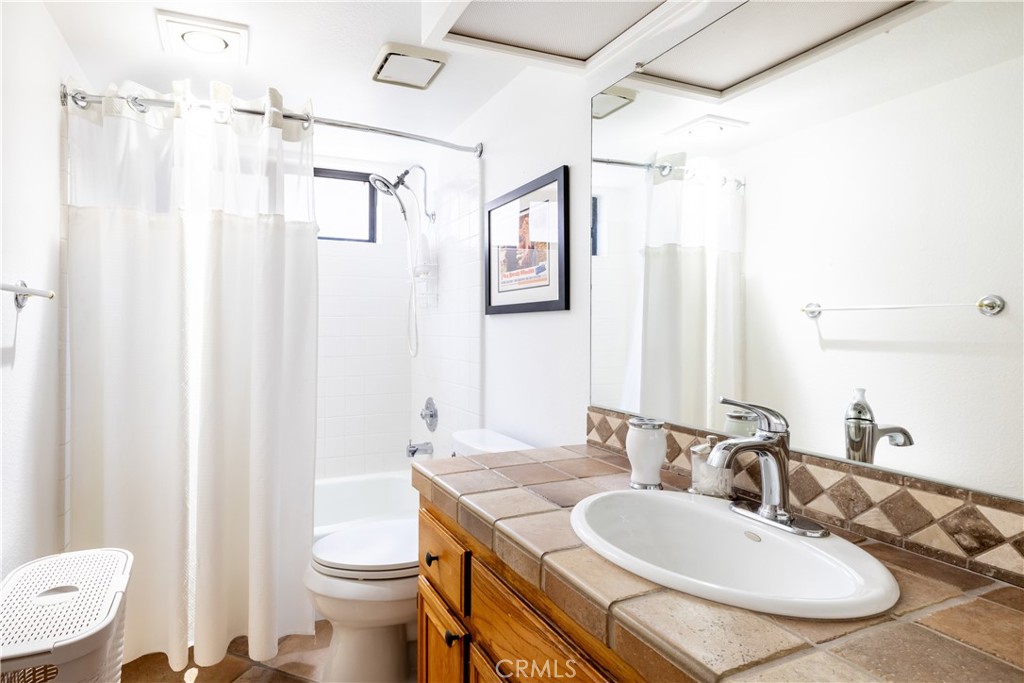 40657 Preston Trail Palm Desert, CA 92211 - Photo 18 of 46 a bathroom with a granite countertop sink toilet and shower
